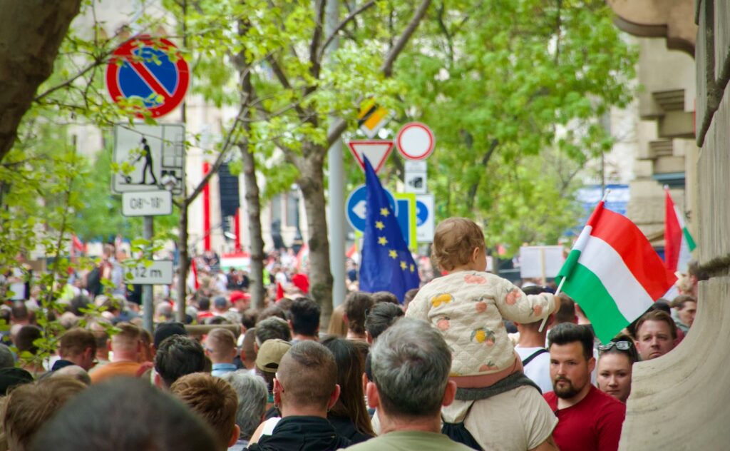 a crowd of people walking down a street